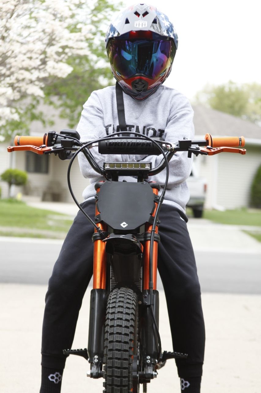 Lifestyle — rider on pit bike in driveway