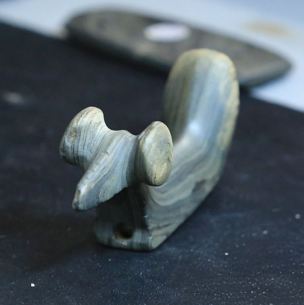 Fine detail — banded slate effigy pipe carving